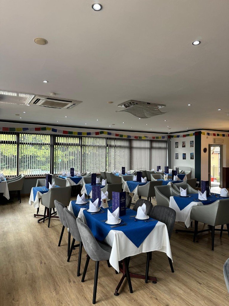The dining room, with blue runners and grey chairs